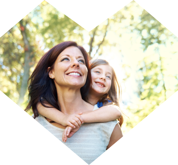 A mother and her child walking through a wooded area